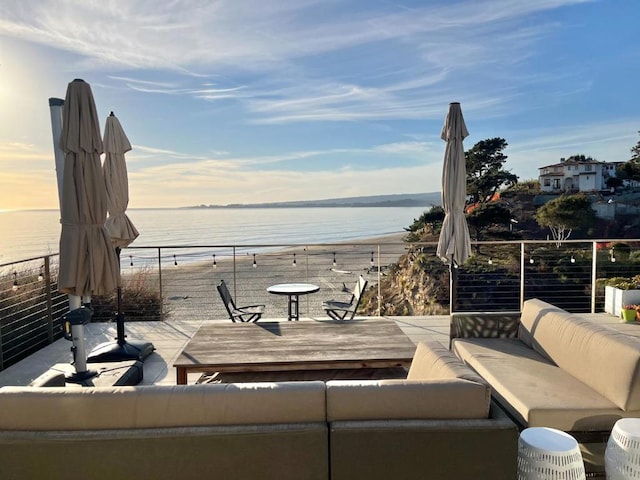 view of patio with outdoor lounge area and a water view