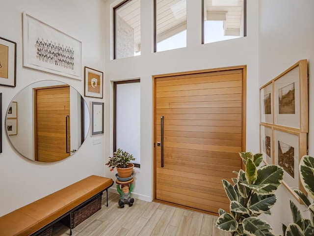 interior space with a towering ceiling and light wood-type flooring