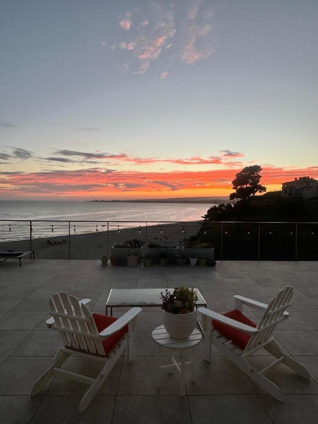 patio terrace at dusk with a water view