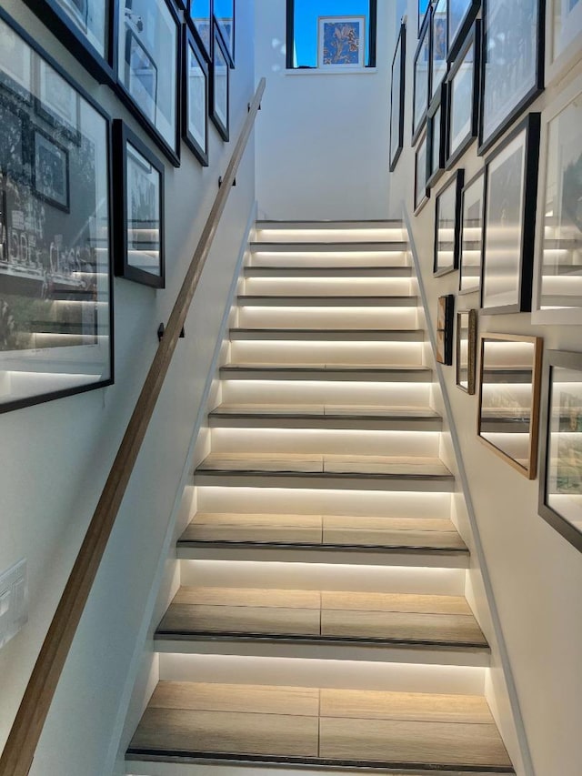 staircase featuring a high ceiling