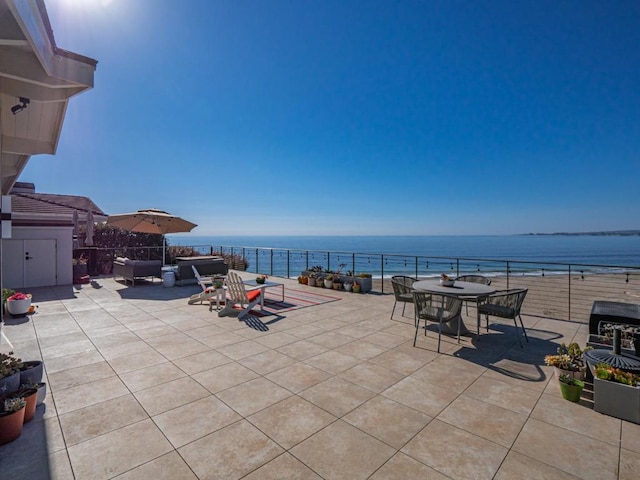 view of patio / terrace with a water view and outdoor lounge area