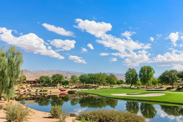 surrounding community with a water and mountain view