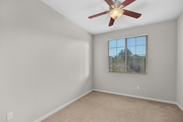 empty room featuring light carpet and ceiling fan