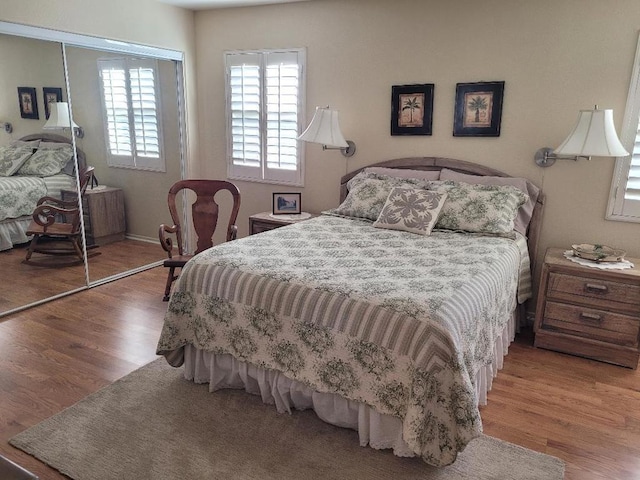 bedroom featuring hardwood / wood-style floors and a closet