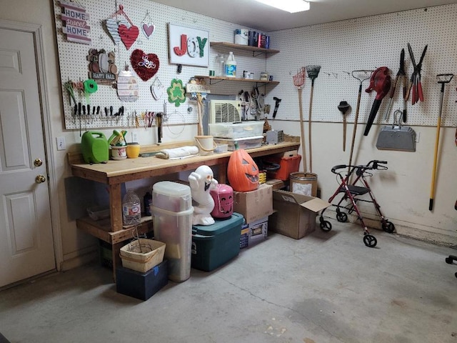 miscellaneous room featuring a workshop area and concrete flooring