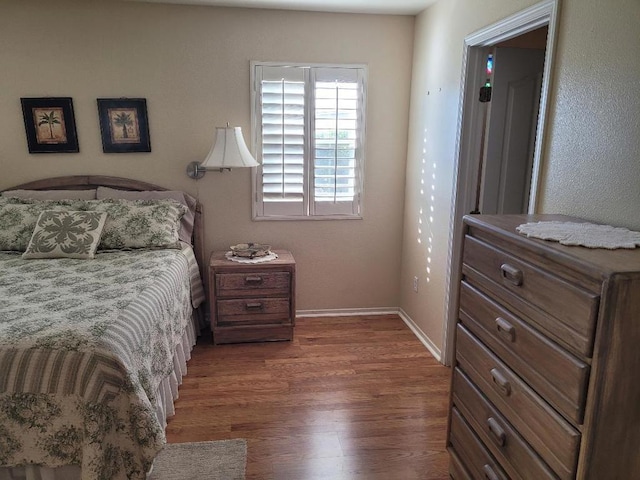 bedroom with dark hardwood / wood-style floors