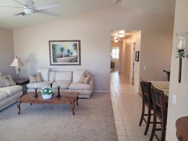 tiled living room featuring ceiling fan and lofted ceiling