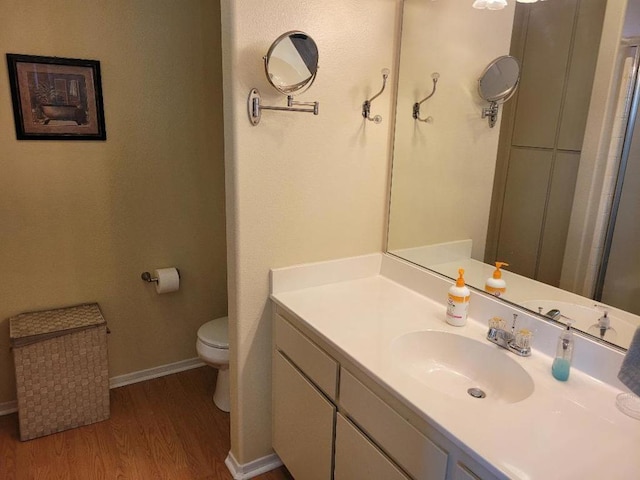 bathroom featuring hardwood / wood-style floors, vanity, and toilet