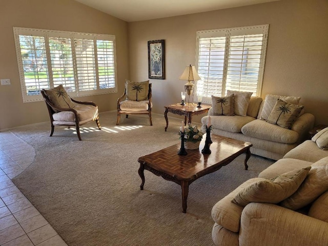 living room featuring lofted ceiling and light tile patterned floors