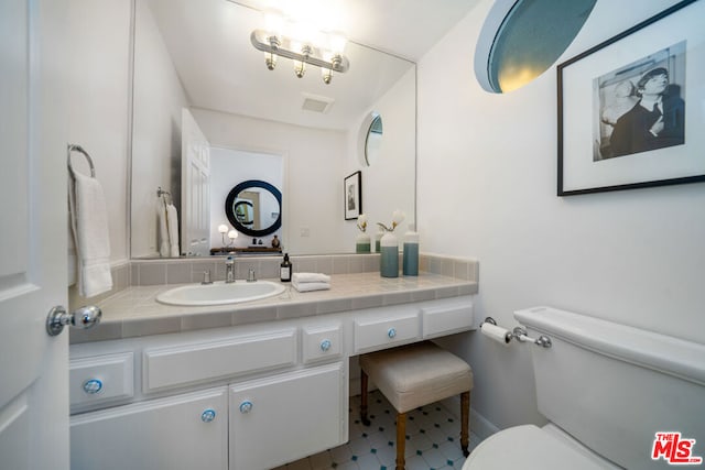 bathroom featuring vanity and toilet