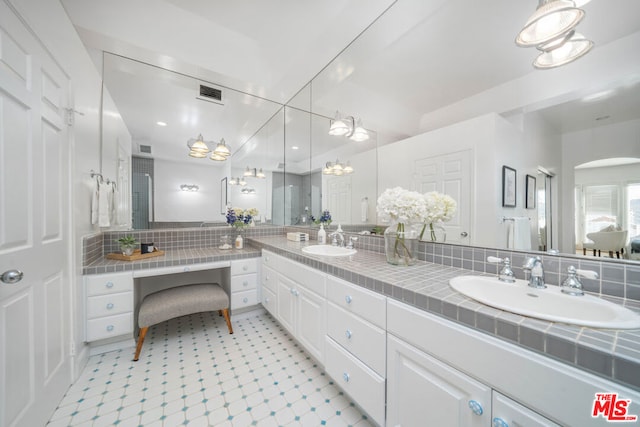 bathroom featuring tasteful backsplash and vanity