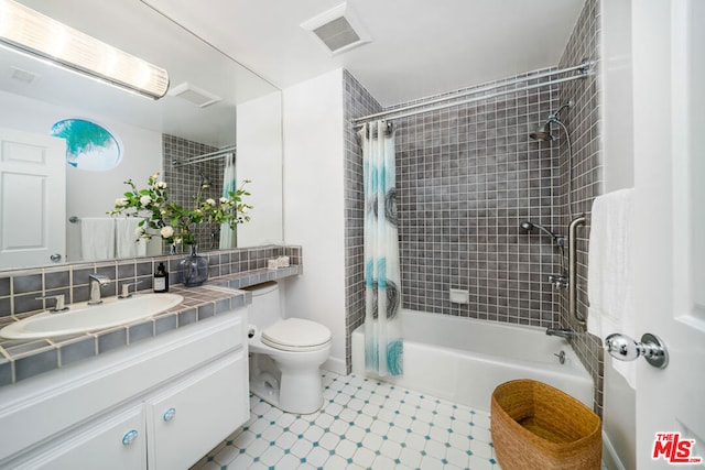 full bathroom featuring tasteful backsplash, vanity, shower / tub combo, and toilet