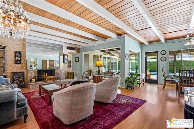 living room featuring hardwood / wood-style floors, beamed ceiling, wood ceiling, and ceiling fan with notable chandelier