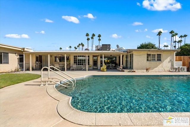 view of pool with a patio and grilling area