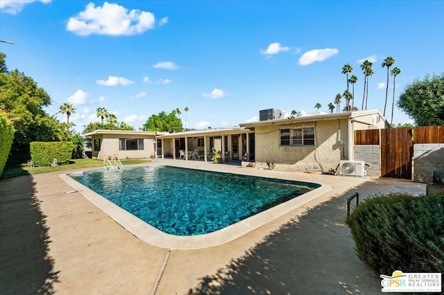 view of pool with ac unit, a patio, and central AC