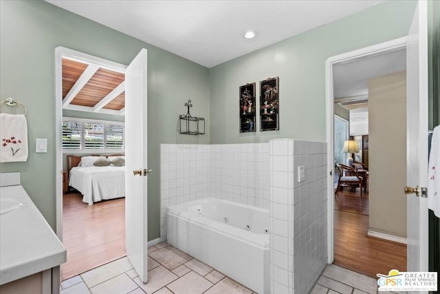 bathroom with a bathing tub, vanity, and hardwood / wood-style flooring