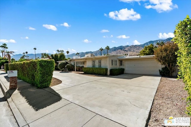 ranch-style house with a mountain view and a garage