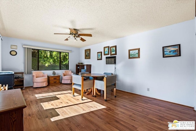 interior space featuring ceiling fan, hardwood / wood-style floors, and a textured ceiling