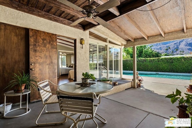 view of patio / terrace with a fenced in pool and ceiling fan