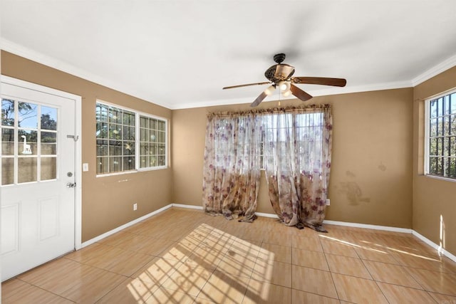 tiled empty room featuring ceiling fan and ornamental molding