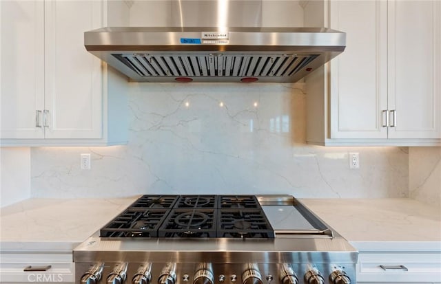 11722 Canoga Dr, Chatsworth, CA 91311 - kitchen featuring wall chimney range hood, stove, light stone countertops, white cabinets, and decorative backsplash