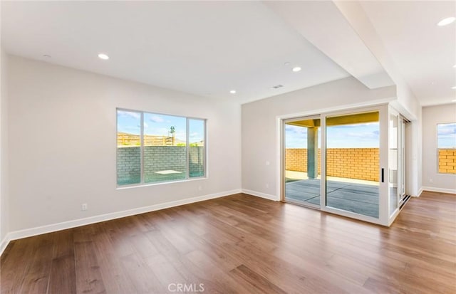 unfurnished room with hardwood / wood-style flooring