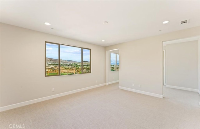 carpeted empty room with a mountain view