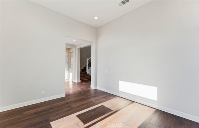 unfurnished room with dark hardwood / wood-style flooring