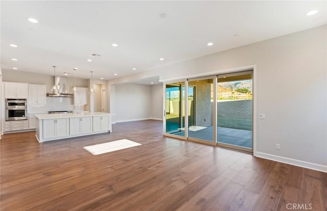 unfurnished living room with dark wood-type flooring