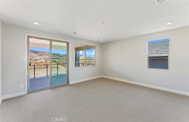 empty room with a mountain view and carpet floors