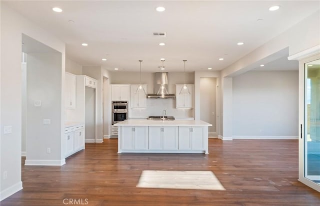 11722 Canoga Dr, Chatsworth, CA 91311 - kitchen with wall chimney range hood, double oven, white cabinets, light countertops, and dark wood-style floors