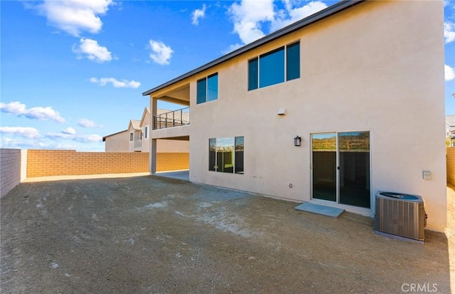 rear view of property with central AC unit