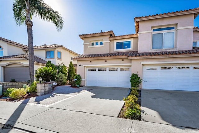 mediterranean / spanish house with a garage