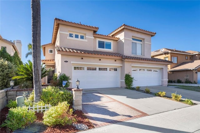 mediterranean / spanish home featuring a garage