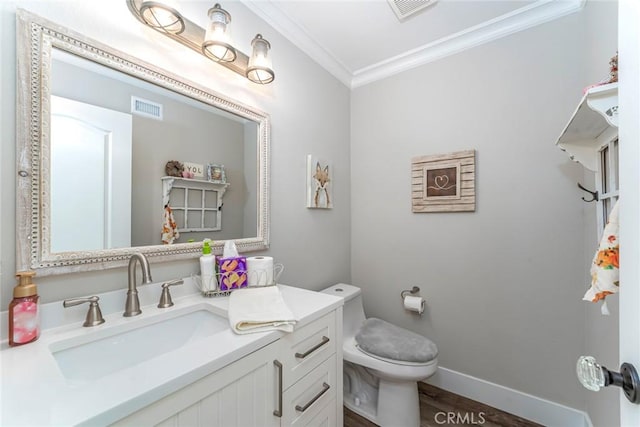 bathroom with vanity, toilet, wood-type flooring, and crown molding