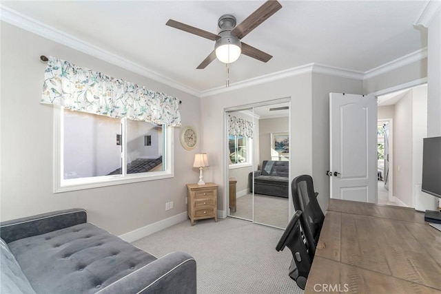 home office featuring ceiling fan, plenty of natural light, light colored carpet, and ornamental molding