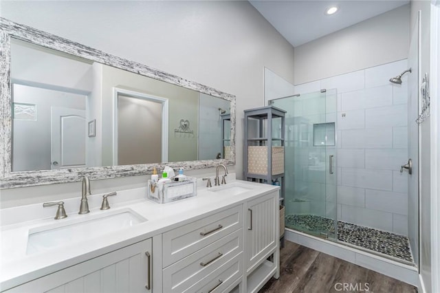 bathroom featuring hardwood / wood-style floors, vanity, and walk in shower