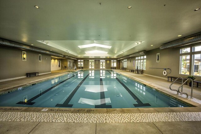 view of swimming pool with a skylight