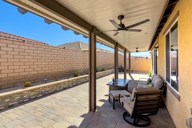 view of patio with an outdoor living space and ceiling fan