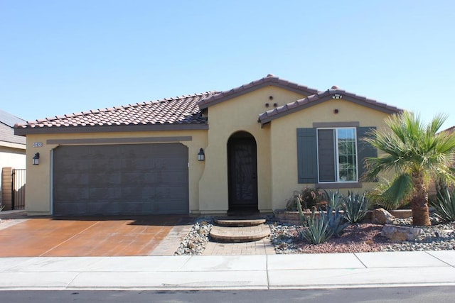 mediterranean / spanish-style home with a garage