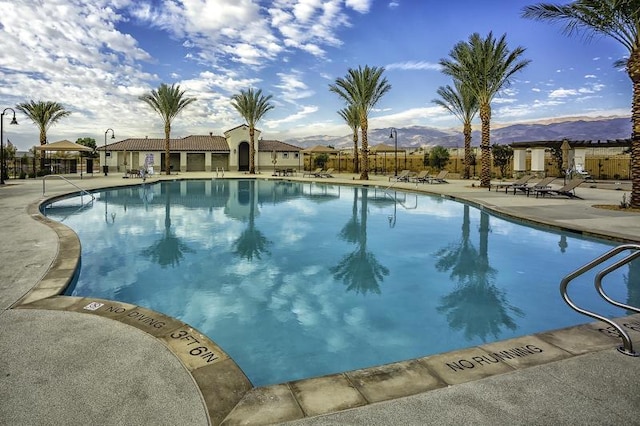 view of pool with a mountain view and a patio