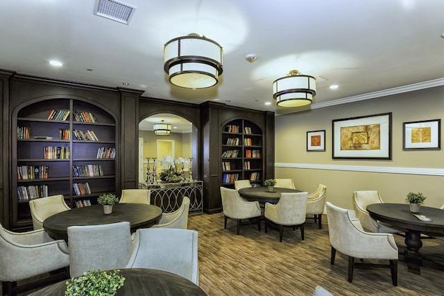 dining space featuring crown molding and hardwood / wood-style flooring