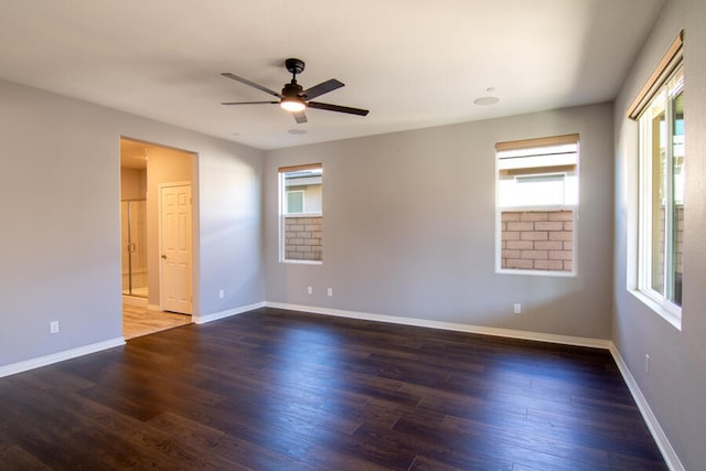 unfurnished room with dark hardwood / wood-style flooring, plenty of natural light, and ceiling fan