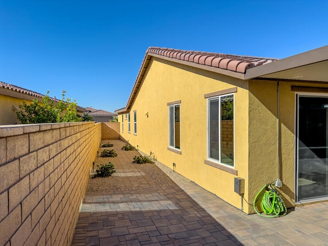 view of side of property with a patio area