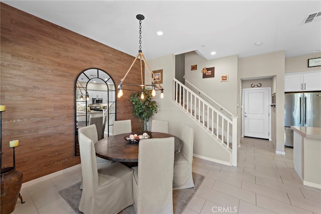 tiled dining space with wood walls