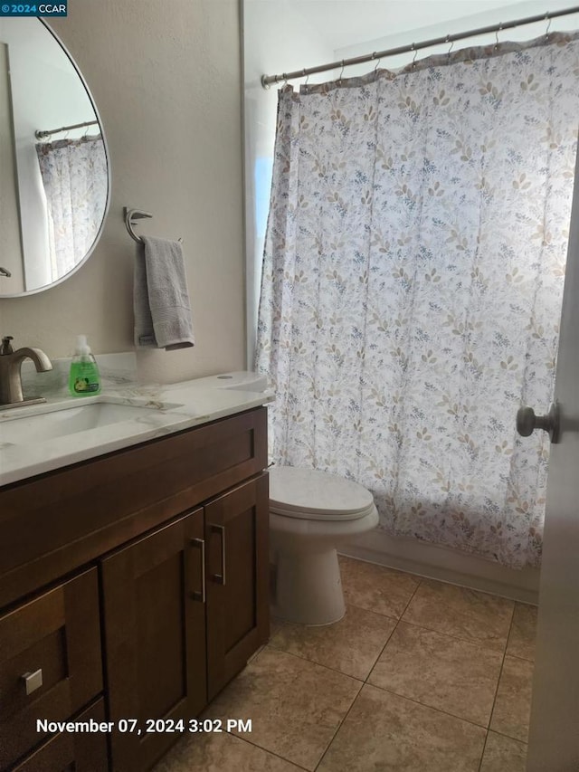 bathroom featuring vanity, tile patterned flooring, and toilet