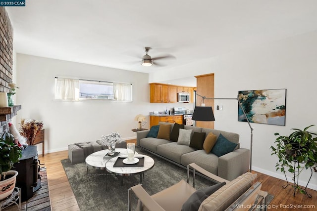 living room with ceiling fan and light hardwood / wood-style flooring