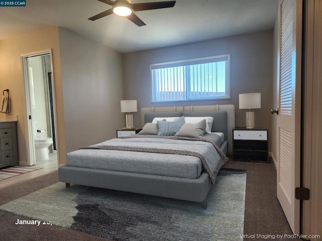 bedroom with dark colored carpet, connected bathroom, and ceiling fan