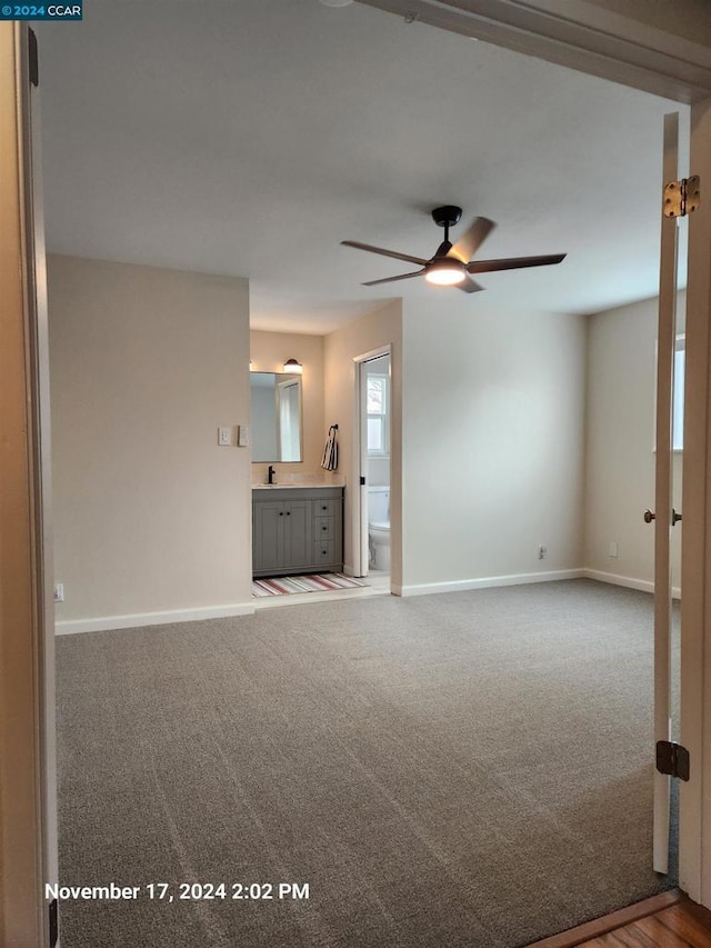 unfurnished living room with carpet floors and ceiling fan