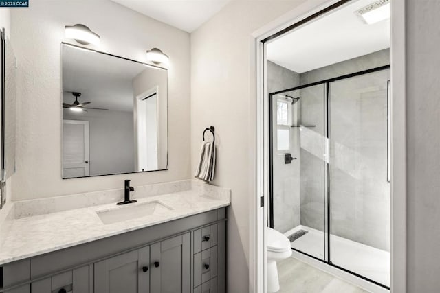 bathroom with an enclosed shower, vanity, wood-type flooring, and toilet